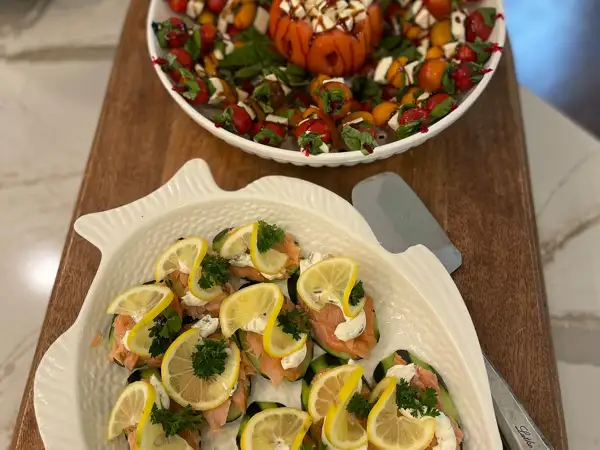 Fresh Chef Catering caprese skewers and smoked salmon bites topped with lemon wedges